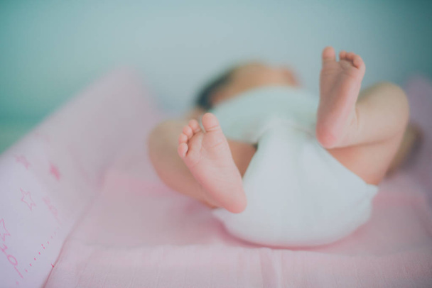 Close-up of tiny baby feet, soft selective focus. - 写真・画像