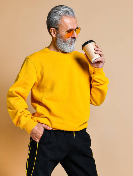 hombre barbudo guapo con taza de papel de café de la mañana - Foto, Imagen