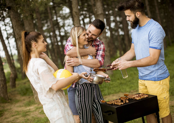 Young people enjoying barbecue party in the nature - Photo, Image