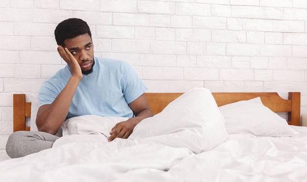 Thoughtful man considering breaking up with girlfriend in bed - Photo, Image