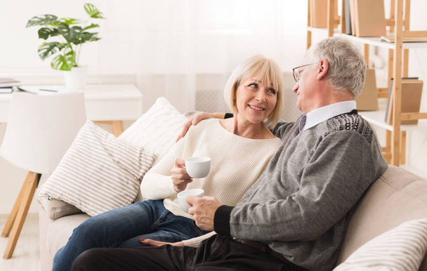 Relaxed senior couple drinking coffee, having rest - Photo, Image