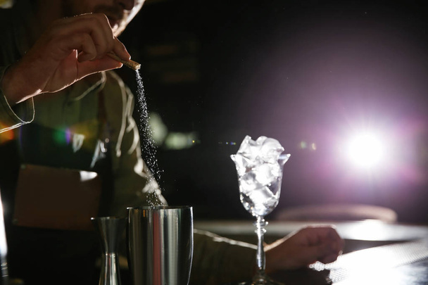 Barman pouring sugar into shaker at counter, closeup with space for text. Making martini cocktail - Foto, immagini