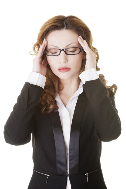 Businesswoman with a headache holding head - Photo, Image