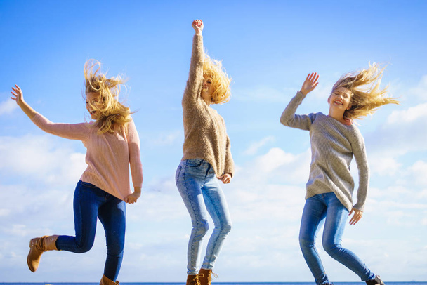 Three women jumping - Фото, изображение