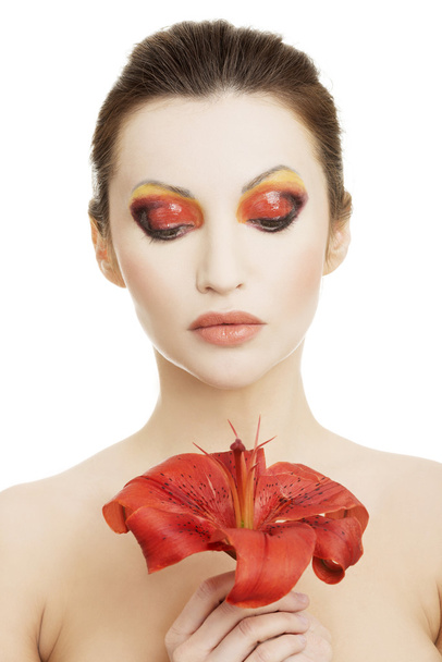 Beautiful woman with a red lily - Φωτογραφία, εικόνα