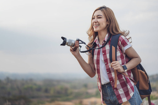 tourist woman taking photo with her camera in nature - Φωτογραφία, εικόνα