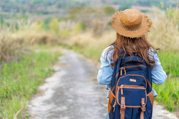 woman with backpack walking on footpath in nature - Foto, Imagem
