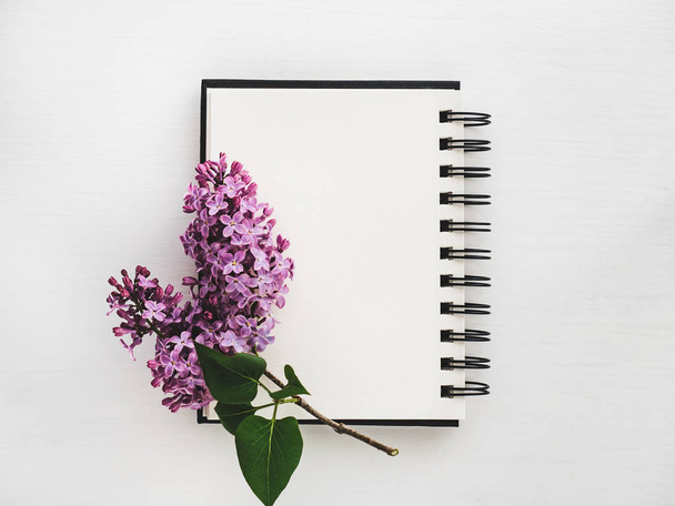 Branch of bright lilac and blank page of sketchbook - Valokuva, kuva