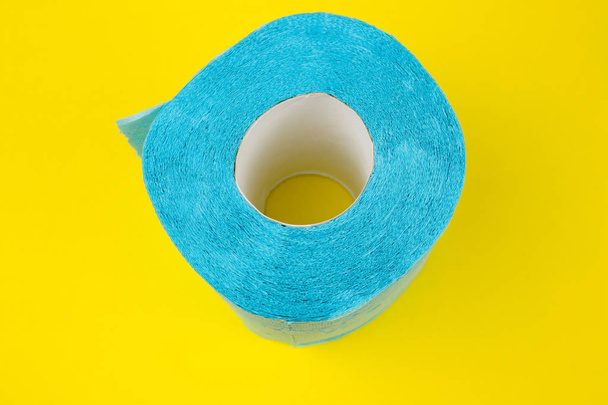 roll of blue  toilet paper on a yellow background - Foto, Imagem