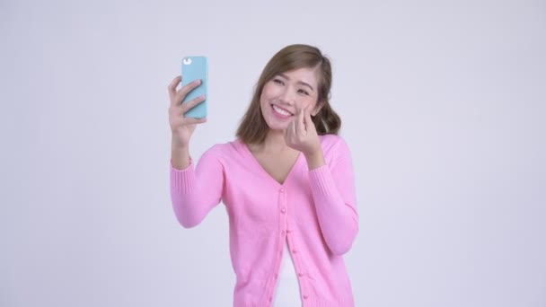 Young happy Asian woman taking selfie - Metraje, vídeo