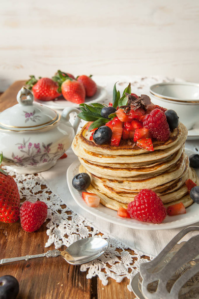 Strawberry chocolate pancakes on a vintage table - Foto, imagen