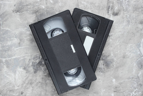 Retro vhs video cassettes from the 80s on a gray concrete background. The oldest medi - Foto, Imagem