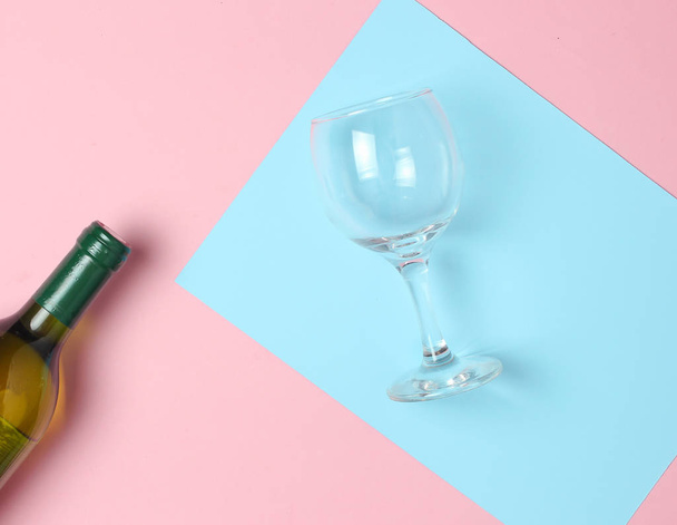 Bottle of wine, glass on a colored pastel background. Top view. Minimalis - Photo, Image