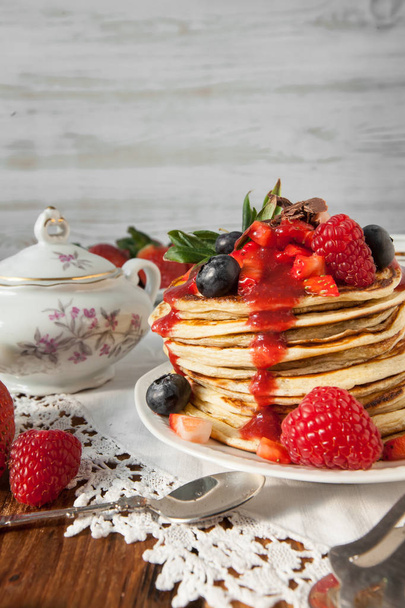 Strawberry chocolate pancakes on a vintage table - Photo, Image