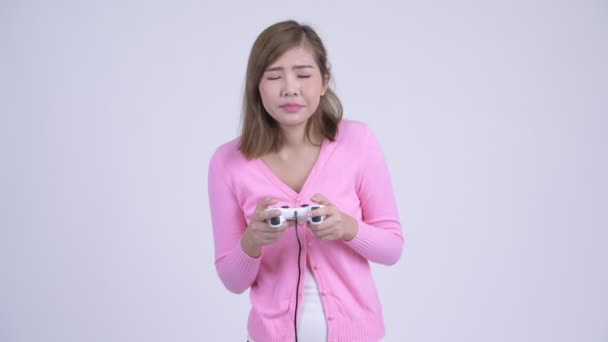 Young tired Asian woman playing games and falling asleep - Footage, Video