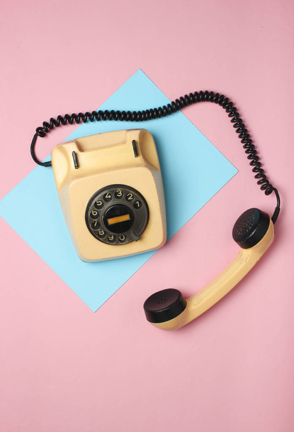 Retro rotary phone from 80s on a colored pastel background. Top view, minimalis - Photo, Image