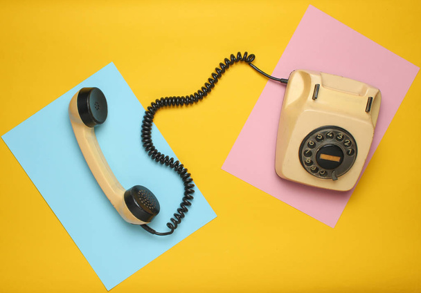 Retro rotary phone from 80s on a colored pastel background. Top view, minimalis - Photo, Image