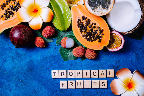 Summer tropical background with exotic various fruits, green pal - Photo, Image