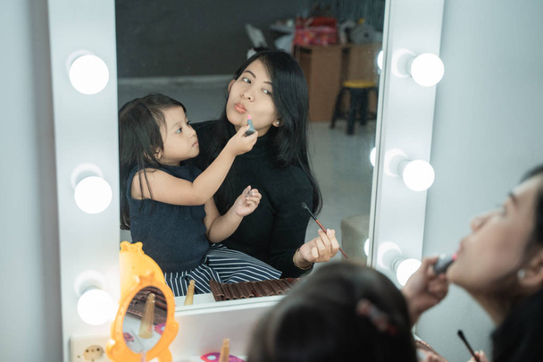 happy mother and kid playing with make up  - 写真・画像