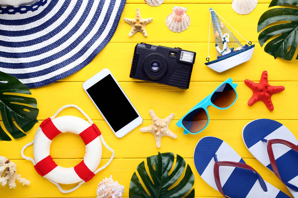 Beach accessories with smartphone and retro camera on wooden tab - Photo, Image