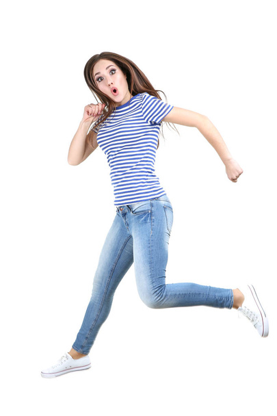 Jumping beautiful girl on white background - 写真・画像