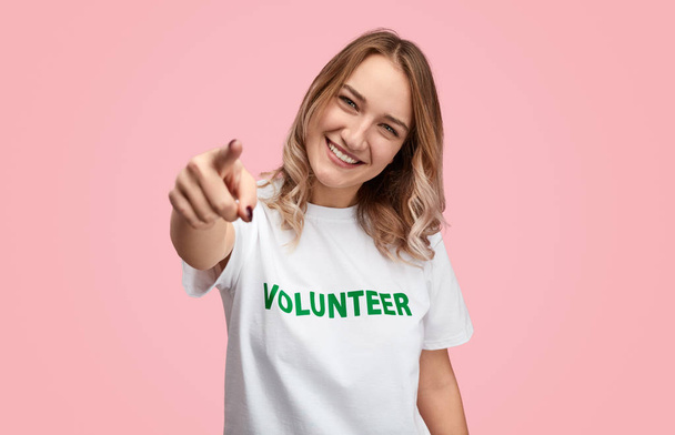 Smiling volunteer pointing at camera - Фото, зображення