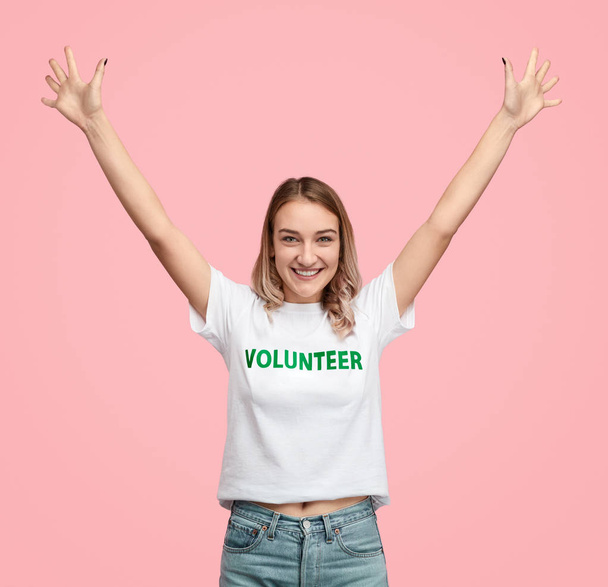 Excited volunteer with raised hands - Valokuva, kuva