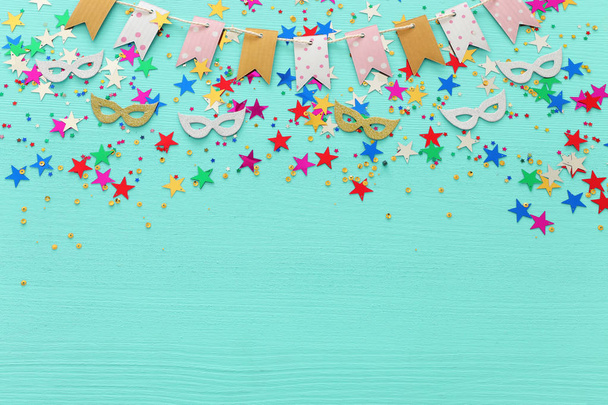 Party colorful confetti over light pastel blue wooden background . Top view, flat lay - Фото, зображення