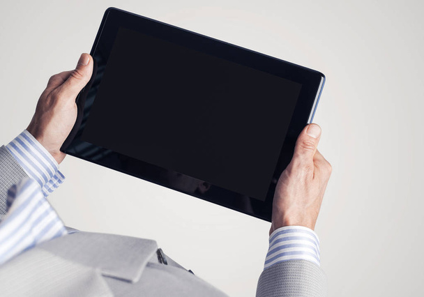 Close up of businessperson using digital tablet with blank display - Фото, изображение