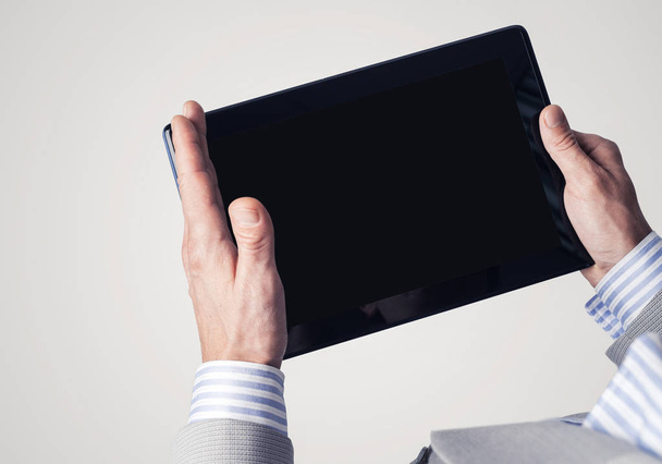 Close up of businessperson using digital tablet with blank display - Foto, immagini