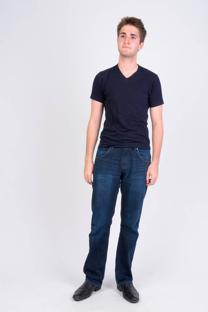 Full body shot of young handsome man thinking - Foto, Imagen