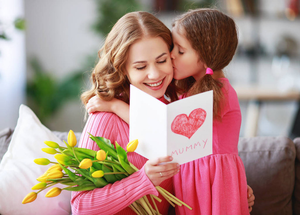 happy mother's day! child daughter   gives mother a bouquet of f - Photo, image