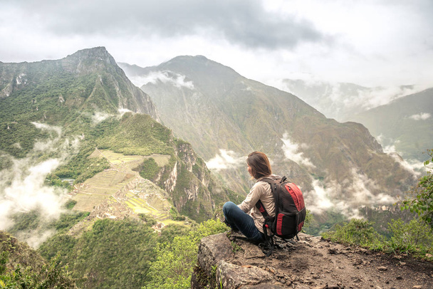 Girl-hiker looking on top of Huayna Picchu, looking on Machu Picchu - Fotó, kép