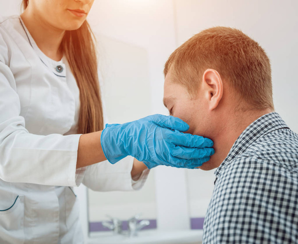 Otolaryngologist examines man's throat. Medical equipment. Diagnostic, healthcare, medical service - Foto, Imagem