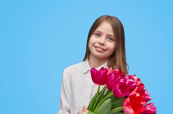 Smiling girl holding pink tulips  - Photo, Image