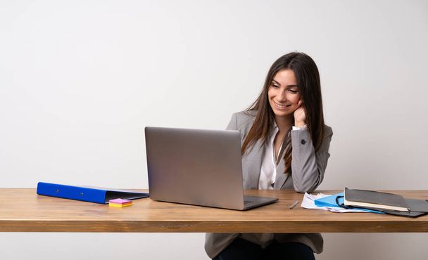 Business woman in a office looking to the side - Photo, Image