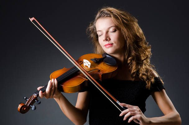 Attractive woman with cello in studio - Фото, зображення