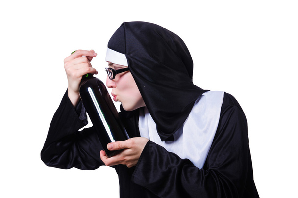 Nun with bottle of wine on white - Foto, afbeelding