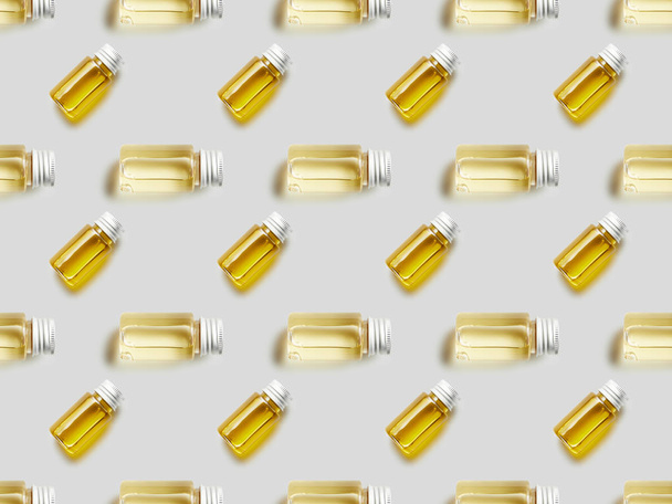 Flat lay with bottles of essential oil on grey background - Φωτογραφία, εικόνα