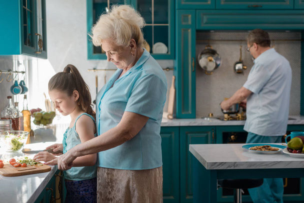 Grandparents and child cooking meal - Photo, image