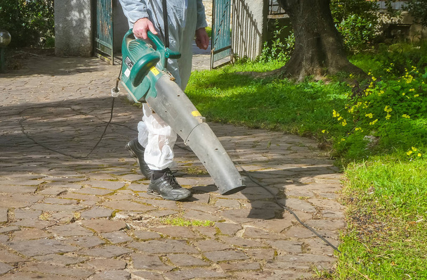 Man using a leaf blower - Фото, изображение