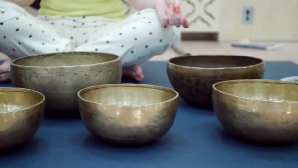 Woman practicing yoga meditation with singing bowl - Footage, Video