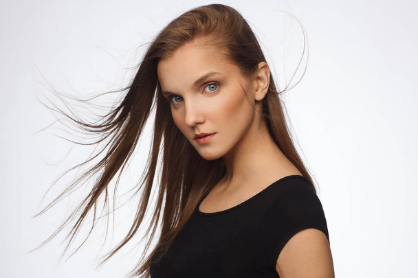 Portrait of a beautiful model with strong emotion, dressed in a black dress - Фото, изображение