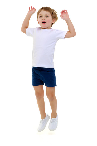 A little boy in a clean white T-shirt is jumping fun. - Foto, Imagem