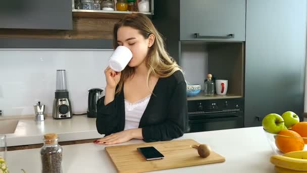 Depressed, unhappy woman reading bad news in the smartphone and throw him on the table. - Footage, Video