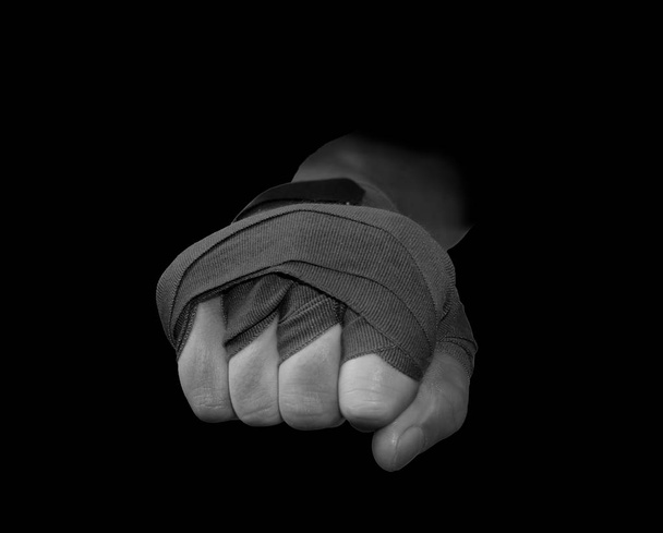 Hand with a dark boxing strap ready to punch in black and white - Φωτογραφία, εικόνα