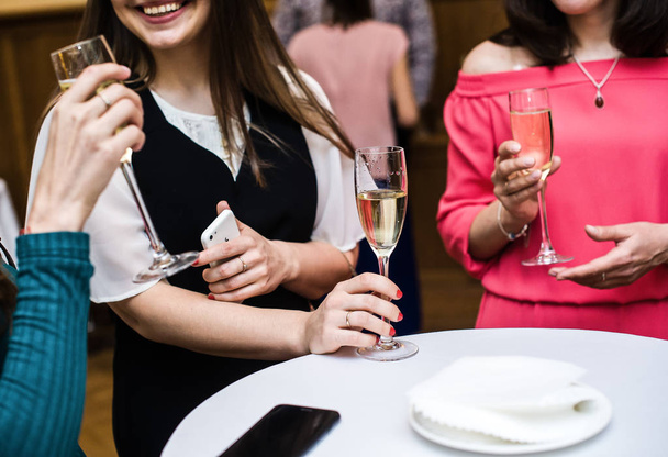 Girls drink champagne and have fun communicating, restaurant - Fotó, kép