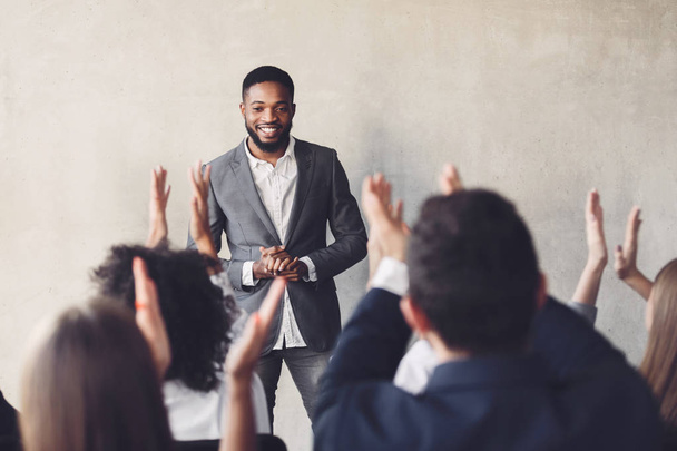 Audience clapping hands to speaker after business seminar - Foto, Imagen