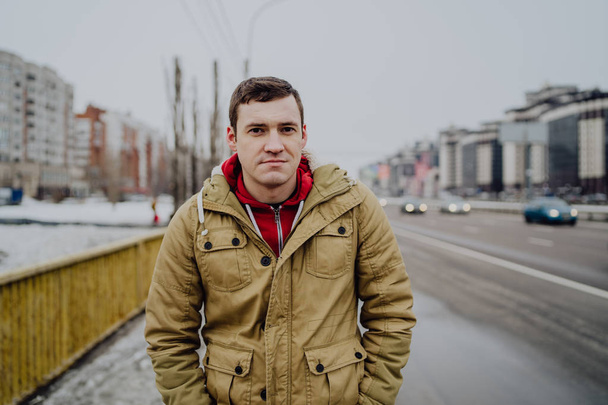 A young handsome man in casual clothes by road  the city - Fotoğraf, Görsel