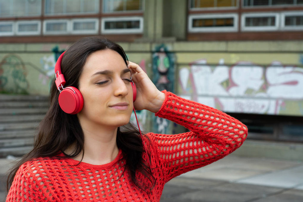 Young woman listening to music - Fotó, kép